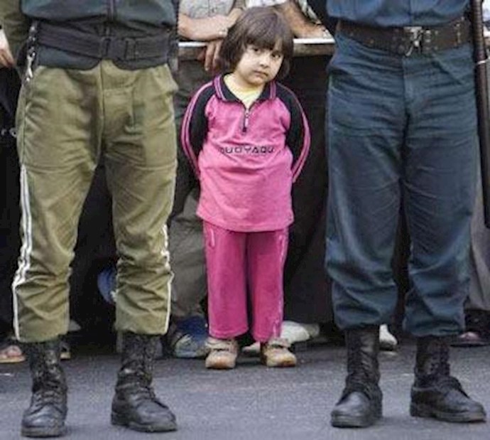 کودکی که به تماشای صحنه اعدام خیابانی آورده شده است! اوج سبعیت آخوندهای ضدبشر و دشمنان حرث و نسل