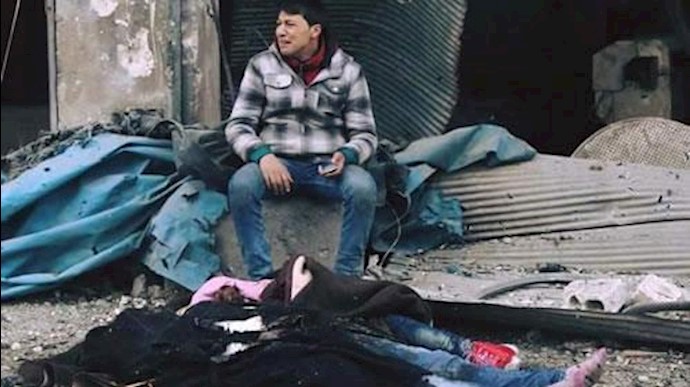 یک پدر سوری در کنار جسد دختر و برادر زاده اش  که بر اثر بمباران کشته شدند