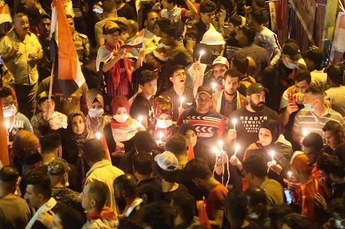 میدان تحریر بغداد - روشن کردن شمع و خواندن قرآن برای شهیدان قیام عراق