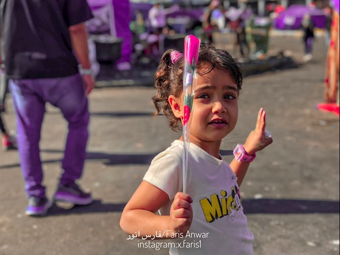 قیام و اعتصاب عمومی در عراق - کودک عراقی،گل در دست و علامت پیروزی