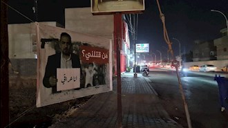 نصب تصاویر شهید ایهاب الوزنی در  خیابانهای کربلا توسط قیام کنندگان