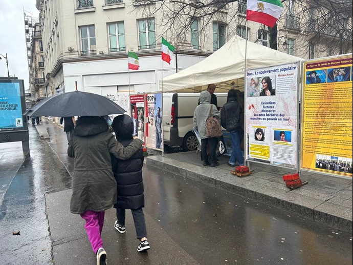 پاریس - برگزاری میز کتاب و نمایش تصاویر شهیدان، در هوای بارانی و سرد پاریس در همبستگی با قیام سراسری - ۱۳دی