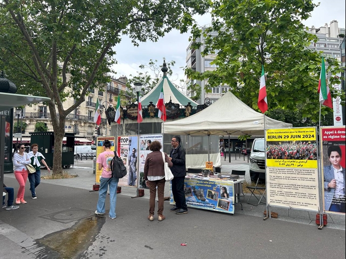 پاریس - برگزاری میز کتاب و نمایش تصاویر شهیدان توسط ایرانیان آزاده - ۳۱خرداد