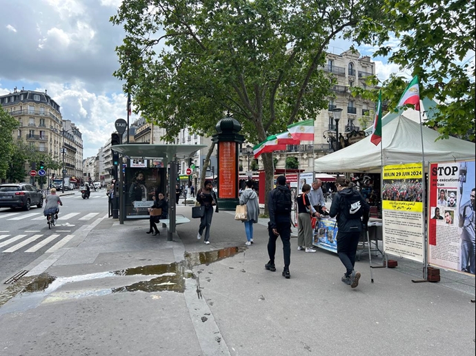 پاریس - برگزاری میز کتاب و نمایش تصاویر شهیدان در همبستگی با قیام سراسری توسط ایرانیان آزاده - ۱۵خرداد